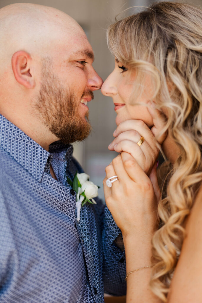Florida Groom pulls in bride for a romantic kiss showing off their new wedding bands 