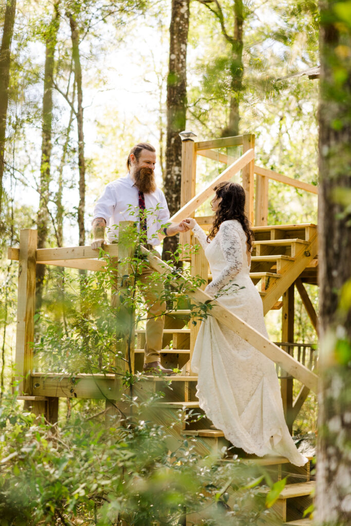 A dreamy, fairytaleish Florida wedding happened out on a friend's property. The Groom leads his new wife up the stairs to the loft deck 