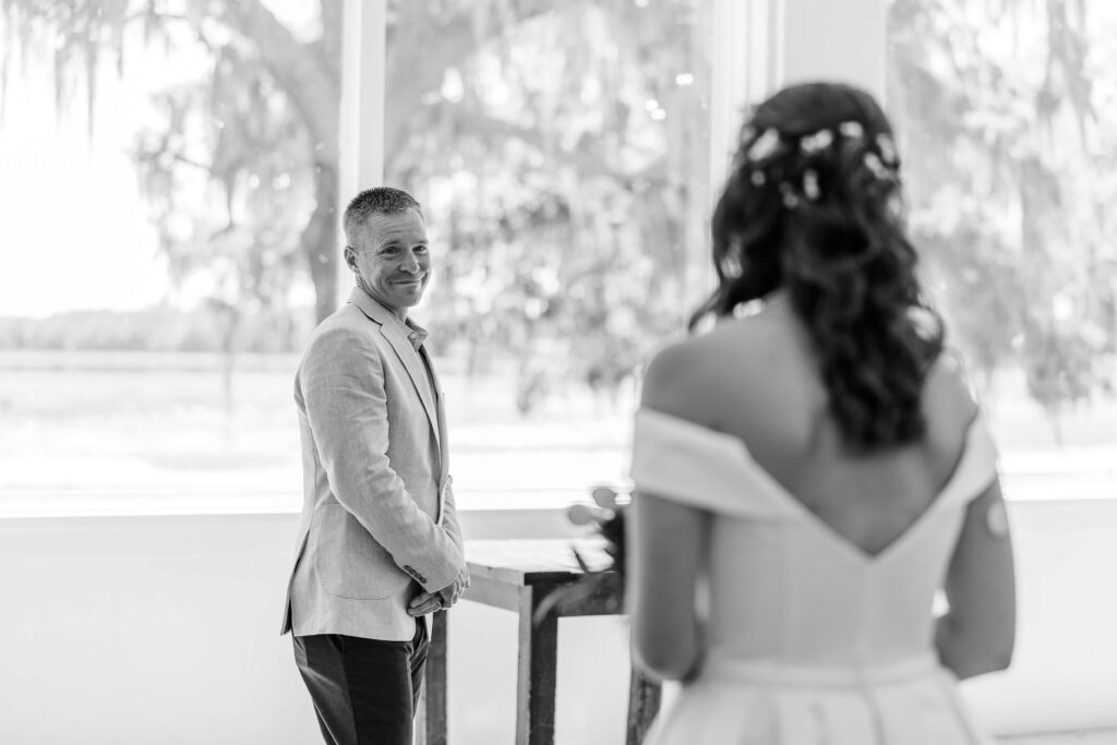 Father of the bride turns to see his daughter in her wedding gown for the first time, at a Florida wedding venue called Lakeside ranches. Their wedding photography package included first look with dad